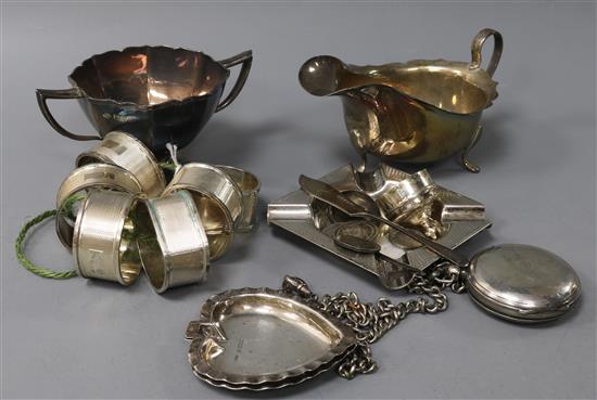 A set of six silver engine-turned napkin rings, a silver pocket watch, sauce boat, sugar bowl and sundries,
